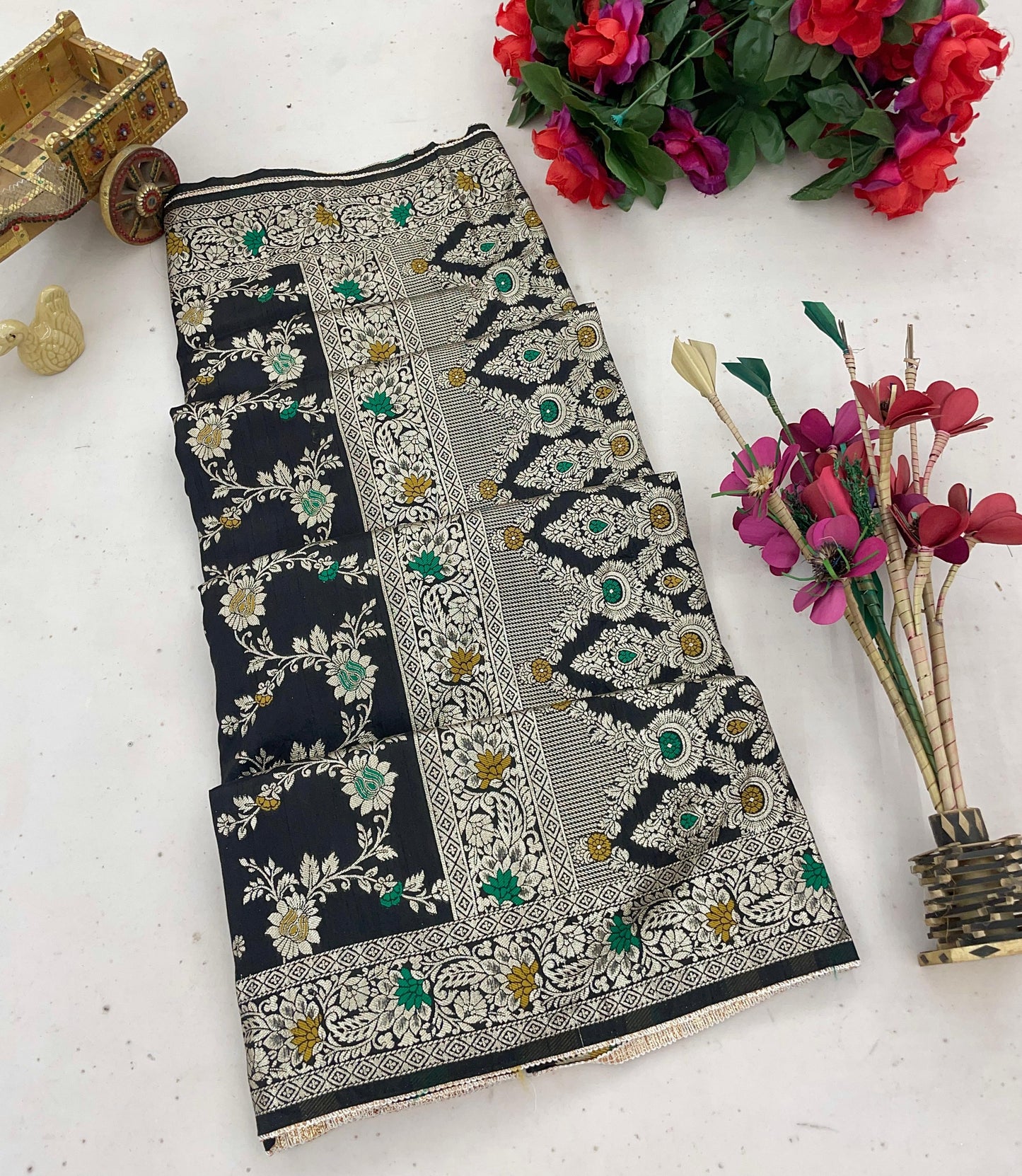 Step into elegance with the Kayra Meenakari Pure Doal saree, crafted from smooth pure Dolasilk fabric. Adorned with sparkling Meenakari work and a charming border lace, this saree adds a playful twist to traditional style. Perfect for those who love to shine with a touch of fun and flair at any celebration!